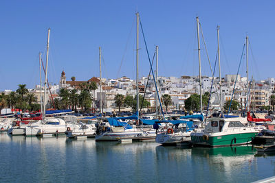 Boats moored at harbor