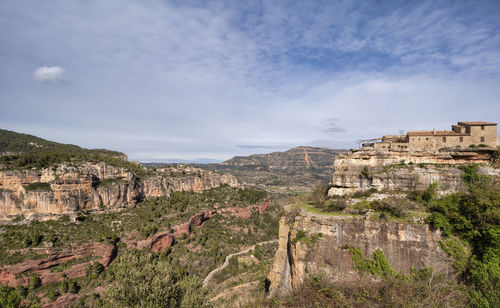 Scenic view of landscape against cloudy sky