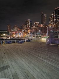 Illuminated buildings against sky at night