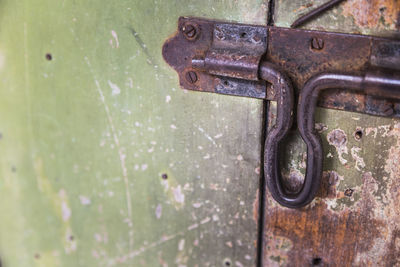 Rusty metal latch on wooden door