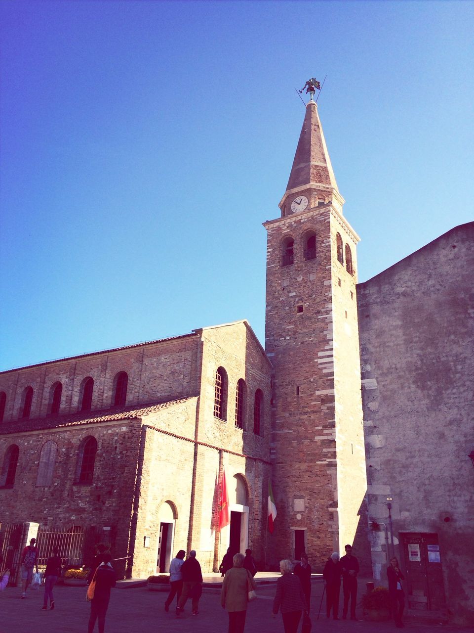 building exterior, clear sky, architecture, built structure, low angle view, blue, sunlight, religion, day, tower, outdoors, place of worship, copy space, old, spirituality, protection, building, house, history