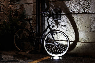 Bicycle leaning against wall