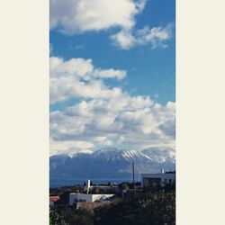 Scenic view of mountains against cloudy sky