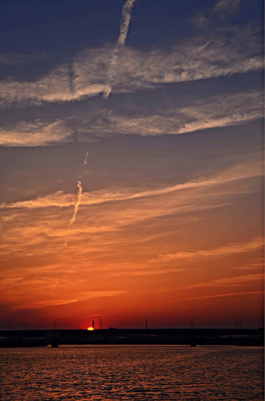 sunset, water, waterfront, sea, sky, scenics, tranquil scene, beauty in nature, tranquility, silhouette, nature, cloud - sky, idyllic, orange color, horizon over water, sun, rippled, cloud, reflection, dramatic sky