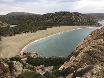 Scenic view of sea and mountains against sky