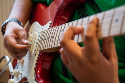 Midsection of person playing guitar