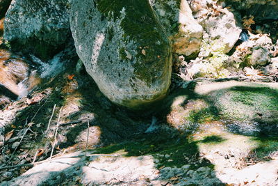 High angle view of stream amidst rocks