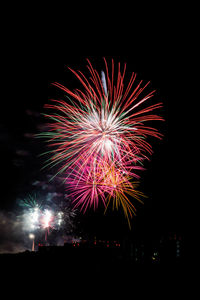 Low angle view of firework display at night