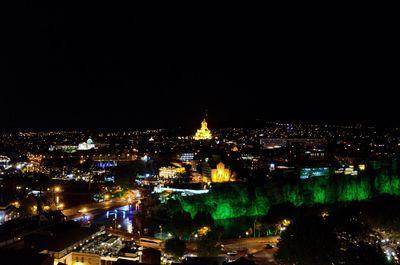 High angle view of buildings lit up at night