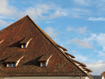 Low angle view of cottage against sky