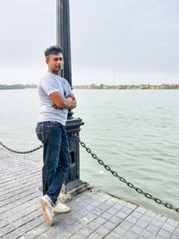 Full length of man standing by sea against sky