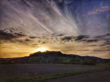 Scenic view of land against sky during sunset