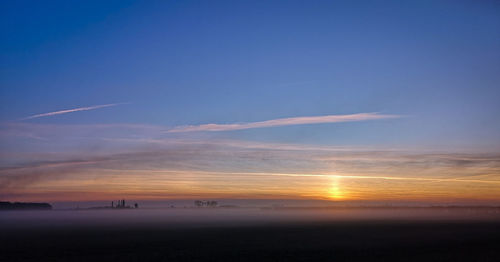 Scenic view of landscape against sky during sunset