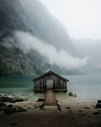 Scenic view of hut in lake against sky