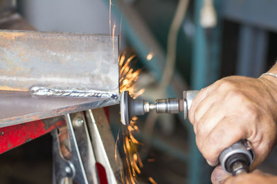 Cropped hands of man working on metal