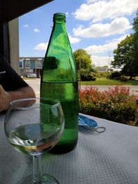 Close-up of hand holding wine glass on table