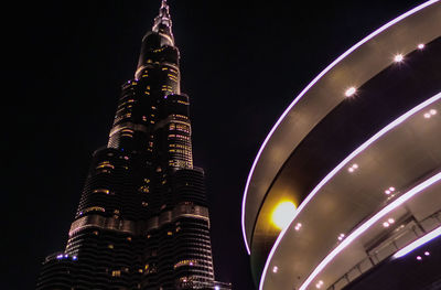 Low angle view of illuminated buildings against sky at night