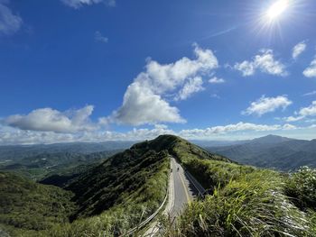 Panoramic view of road amidst landscape against sky