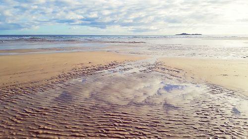 Scenic view of beach against sky