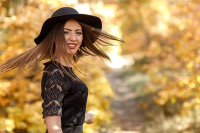 Portrait of young woman wearing hat