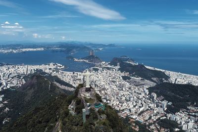 High angle view of buildings by sea against sky