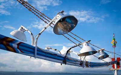 Lamps mounted on boat against sky