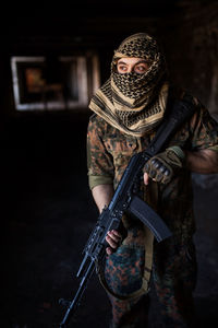 Portrait of serious middle eastern man with ak-47