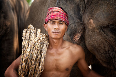 Portrait of shirtless man standing outdoors