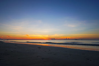 Scenic view of beach against sky during sunset