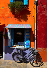 Bicycles parked on footpath against building