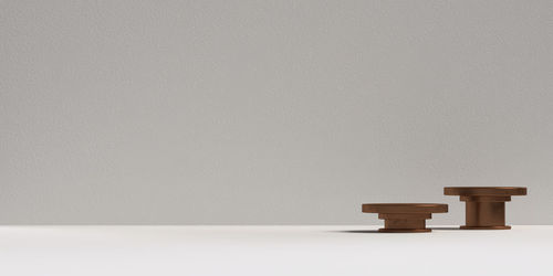 Close-up of empty wooden table against wall at home