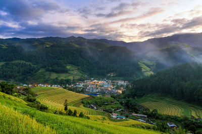 Scenic view of agricultural field and mountains against sky