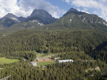 Scenic view of field and mountains against sky