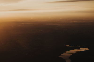 Aerial view of cityscape against sky during sunset