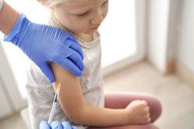 Doctor giving vaccine to girl