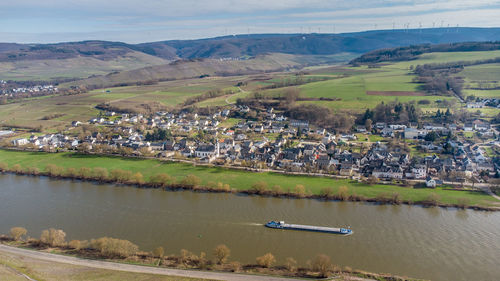 Scenic view of lake and buildings in town