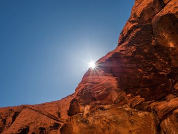 Low angle view of rock formation against clear sky