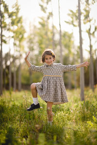 Portrait of girl standing on field