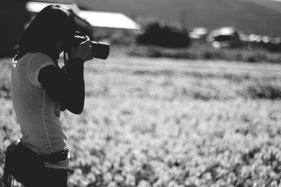 Man photographing on field