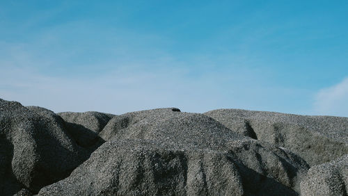Low angle view of rocks against sky