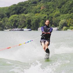 Man waterskiing in river