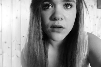 Close-up portrait of young woman at home