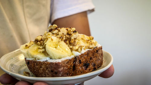 Close-up of hand holding cake