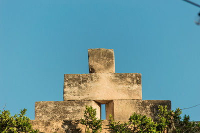 Low angle view of fort against clear blue sky