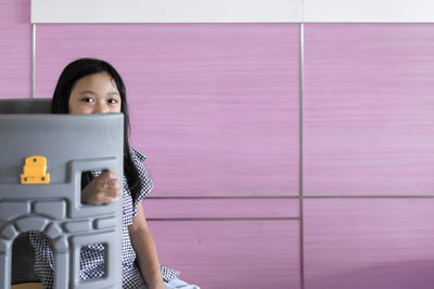 Portrait of woman photographing with mobile phone