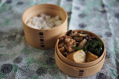 Close-up of rice and meat in bowls on table