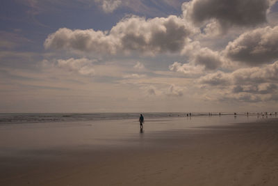 Person on beach against sky