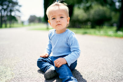 Portrait of cute girl sitting outdoors