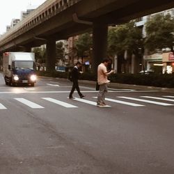 People walking on road in city