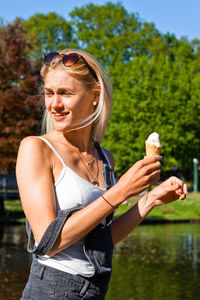 Smiling young woman standing outdoors